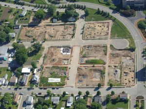 Aerial view of project area, showing multiple square and rectangular excavated areas in residential context.