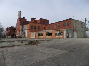 Several abandoned, historic brick buildings.