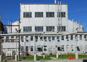 Facade of large, corrugated metal industrial building.