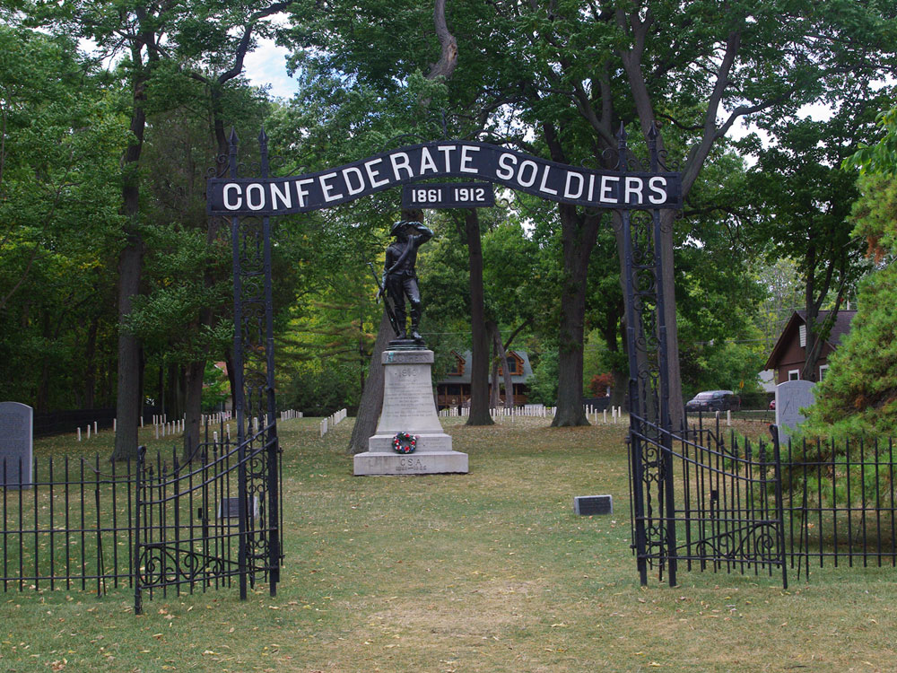 Metal entrance gate to Confederate cemetery with overhead sign reading 