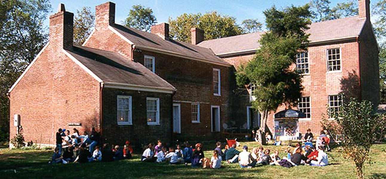 Students seated on lawn.