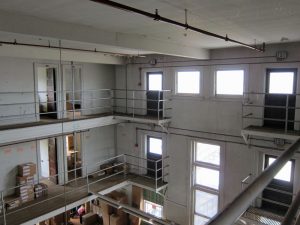 Interior view of building from third-floor railing.
