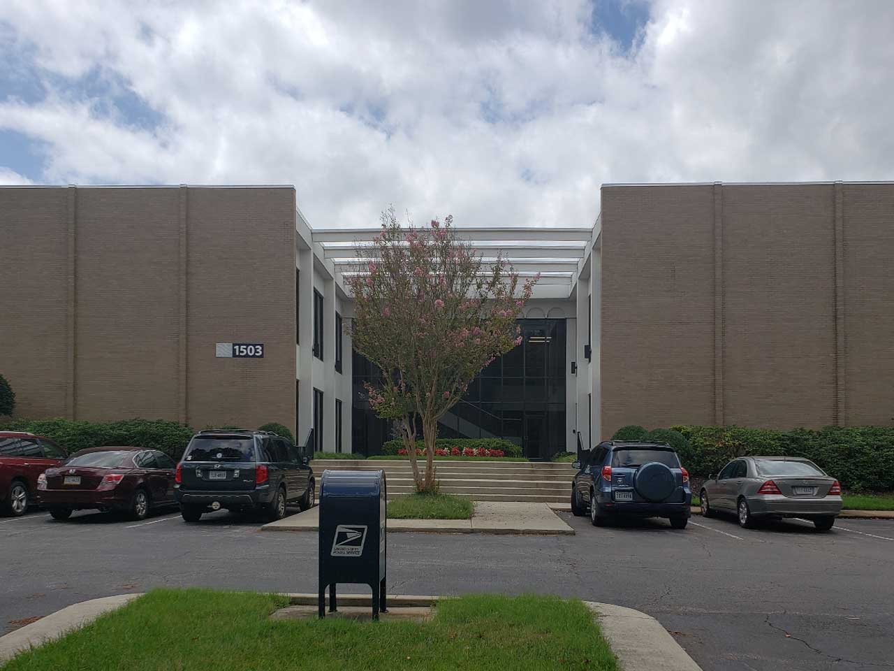 Location of Virginia office within modern brick building with no fenestration on the facade.