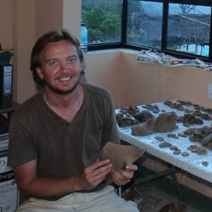 Davies posing with recovered artifacts.
