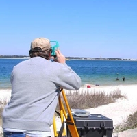 Brian viewing ocean through special equipment from beach.