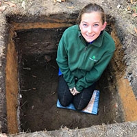 Rachael posing within excavated pit.