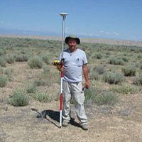 Randy in field with survey equipment.