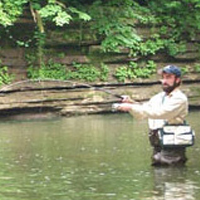 Andy fishing in river.
