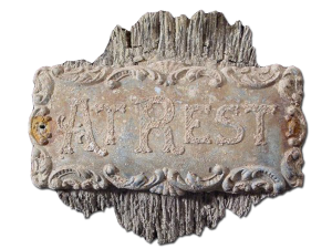 Historic metal plaque from casket, reading "At Rest."