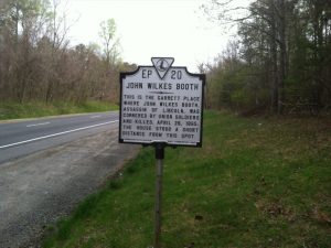 Roadside sign saying "EP 20 / John Wilkes Booth / This is the Garrett Place where John Wilkes Booth, assassin of Lincoln, was cornered by Union soldiers, and killed, April 26, 1865. The house stood a short distance from this spot."