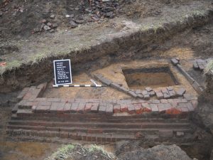 Rectangular brick structure uncovered during excavation.