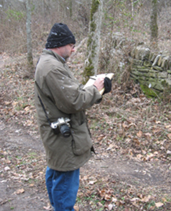 Medium-shot profile of Trent conducting fieldwork.