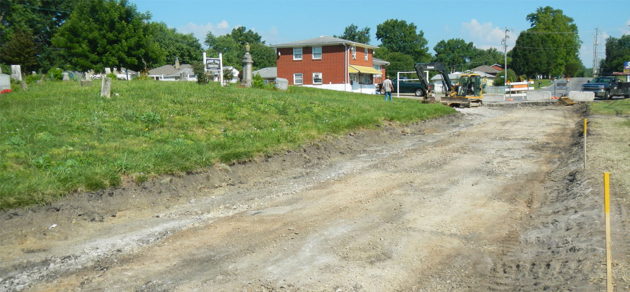 Cemetery shown from stripped roadway.