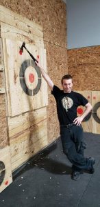 Tommy posing with axe-throwing target.